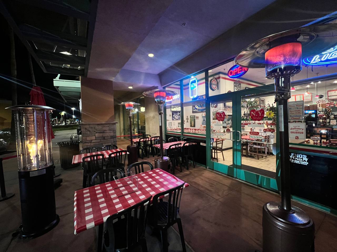 Photo of a outdoor seating at night in front of restraunt.
